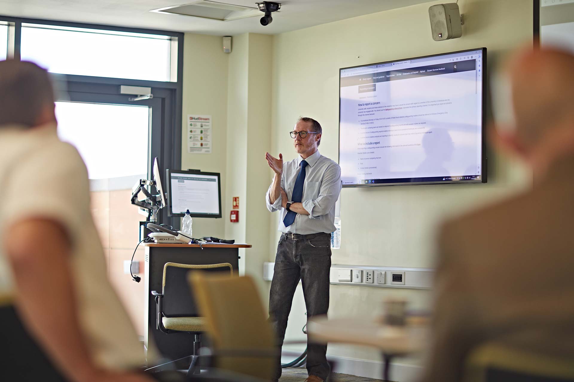 A man talking to a room full of people