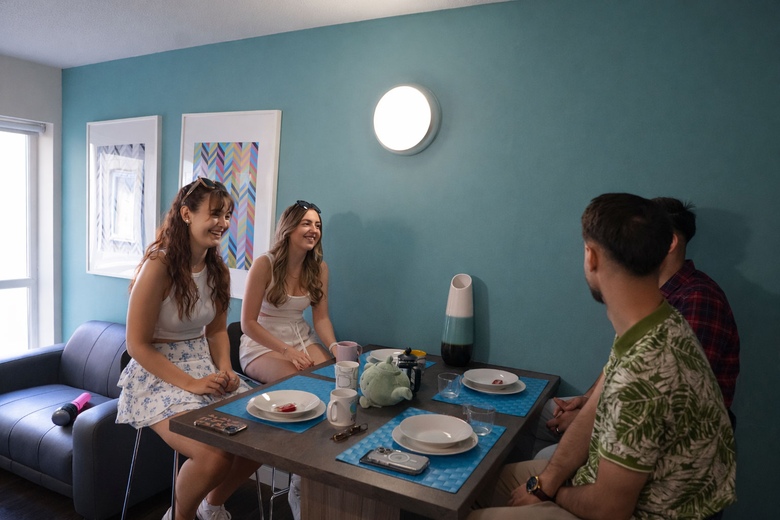 A group of students sat a breakfast bar in student accommodation.