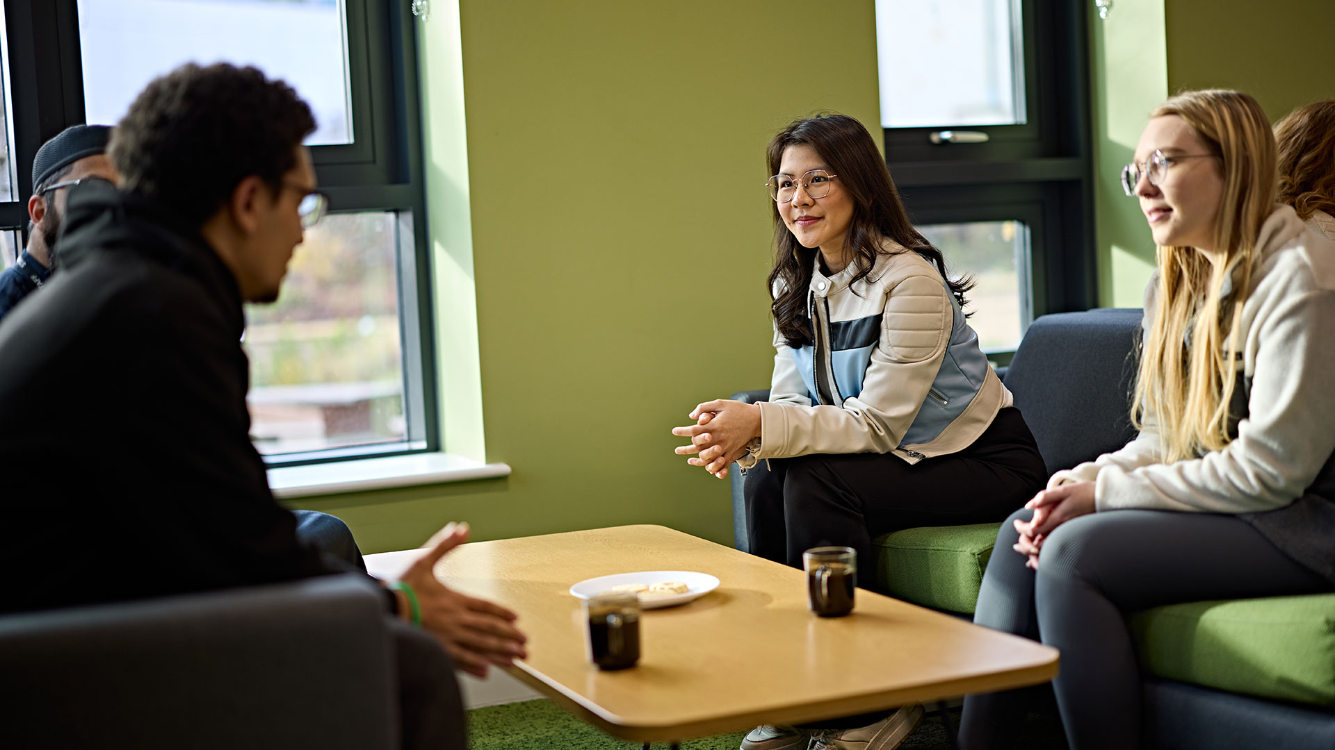 Student sit and chat in the communal space.