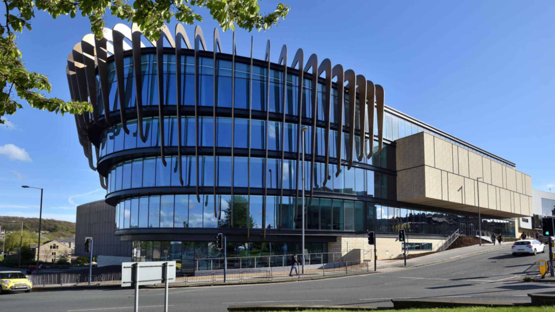 A picture of the Oastler Building from the turning circle on a summers day with sun and clear sky