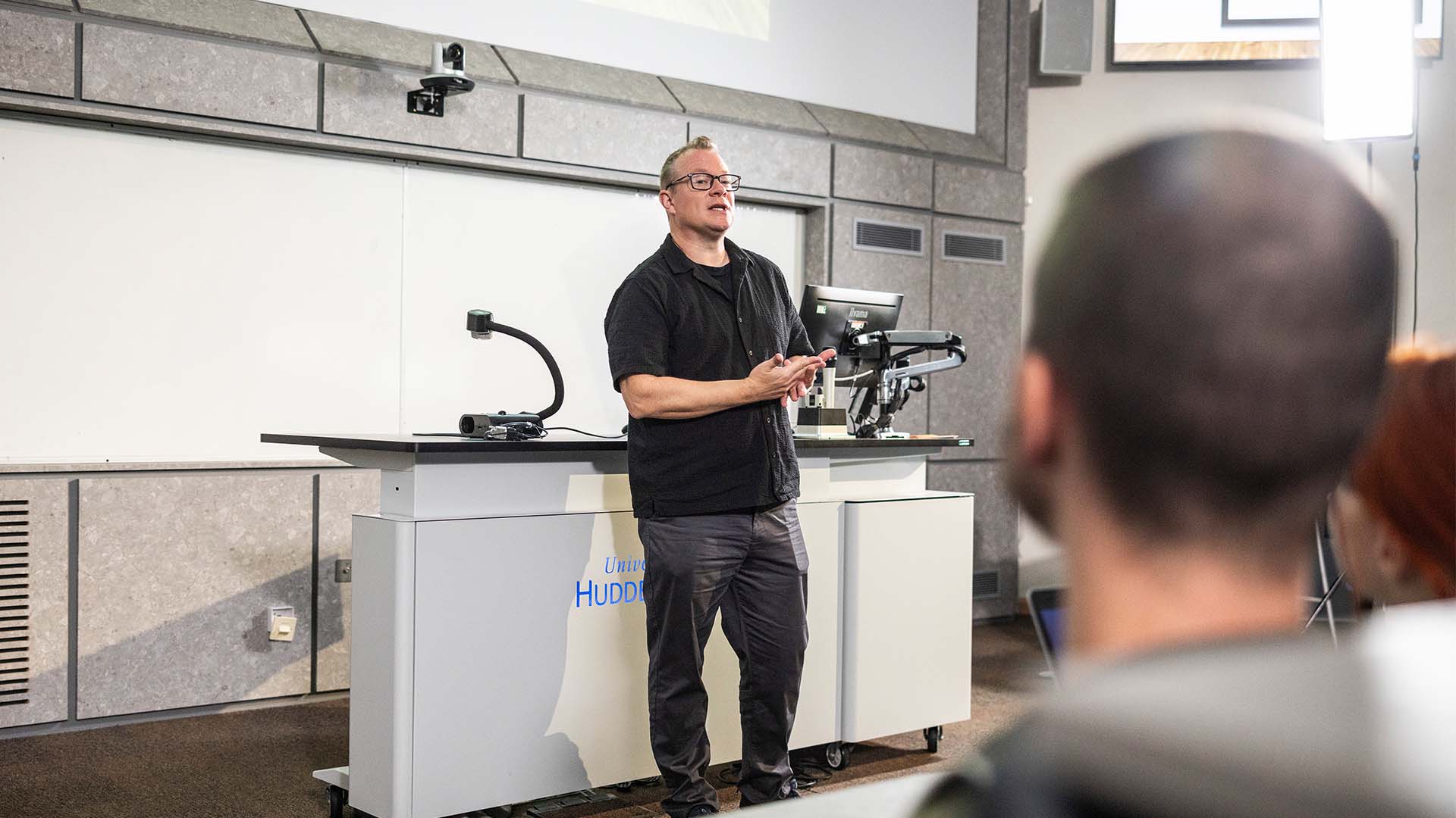Andrew Johnston delivering a business lecture in a lecture room