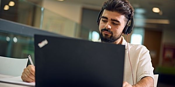 Student watching a webinar on a laptop