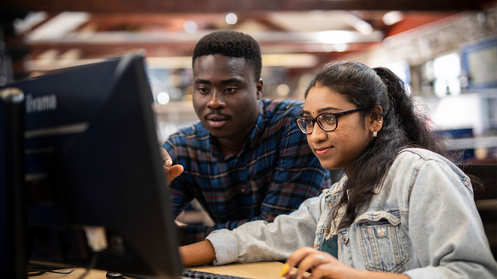Teacher and student in computing classroom