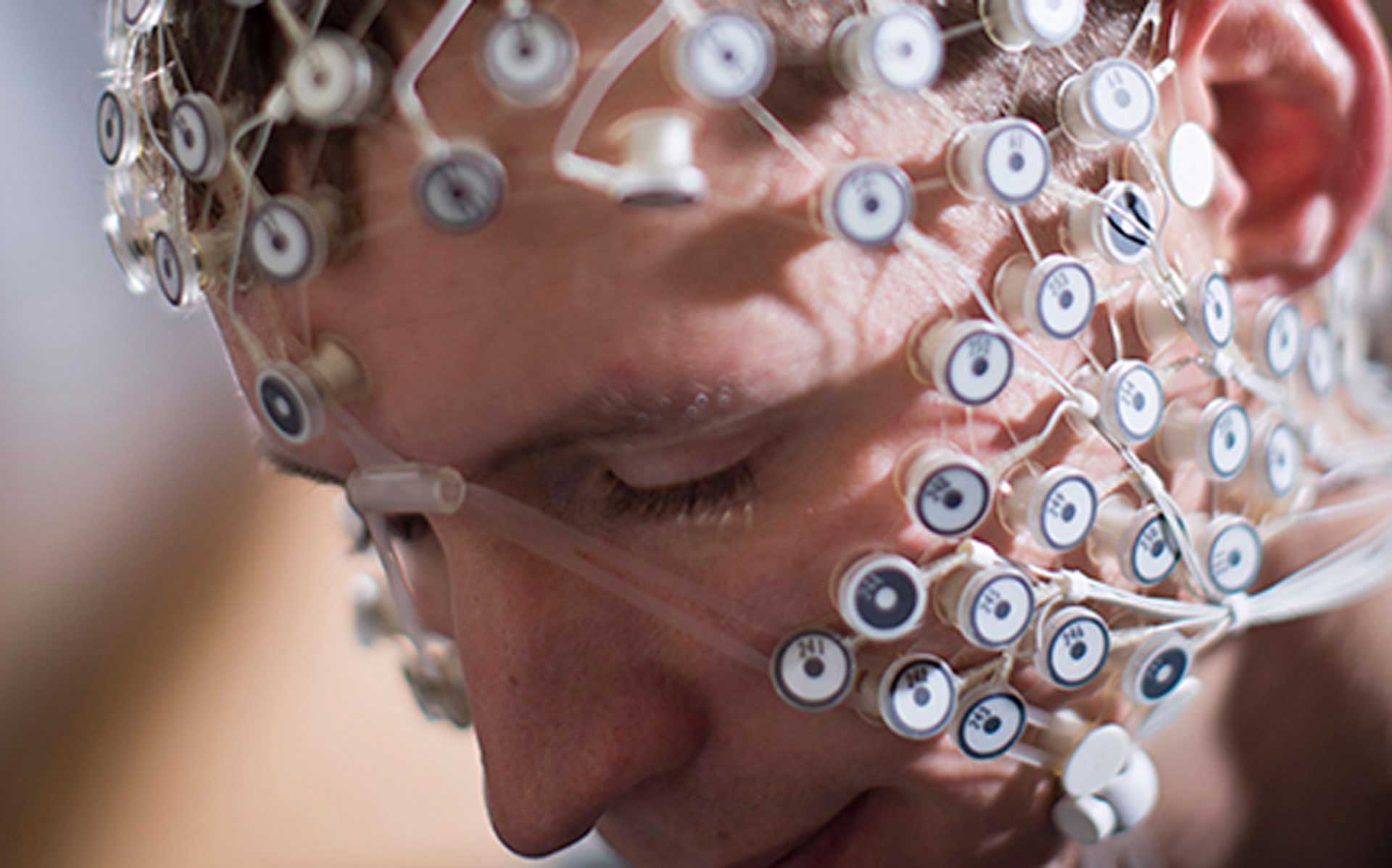 A student with sensor nodes placed around their head.