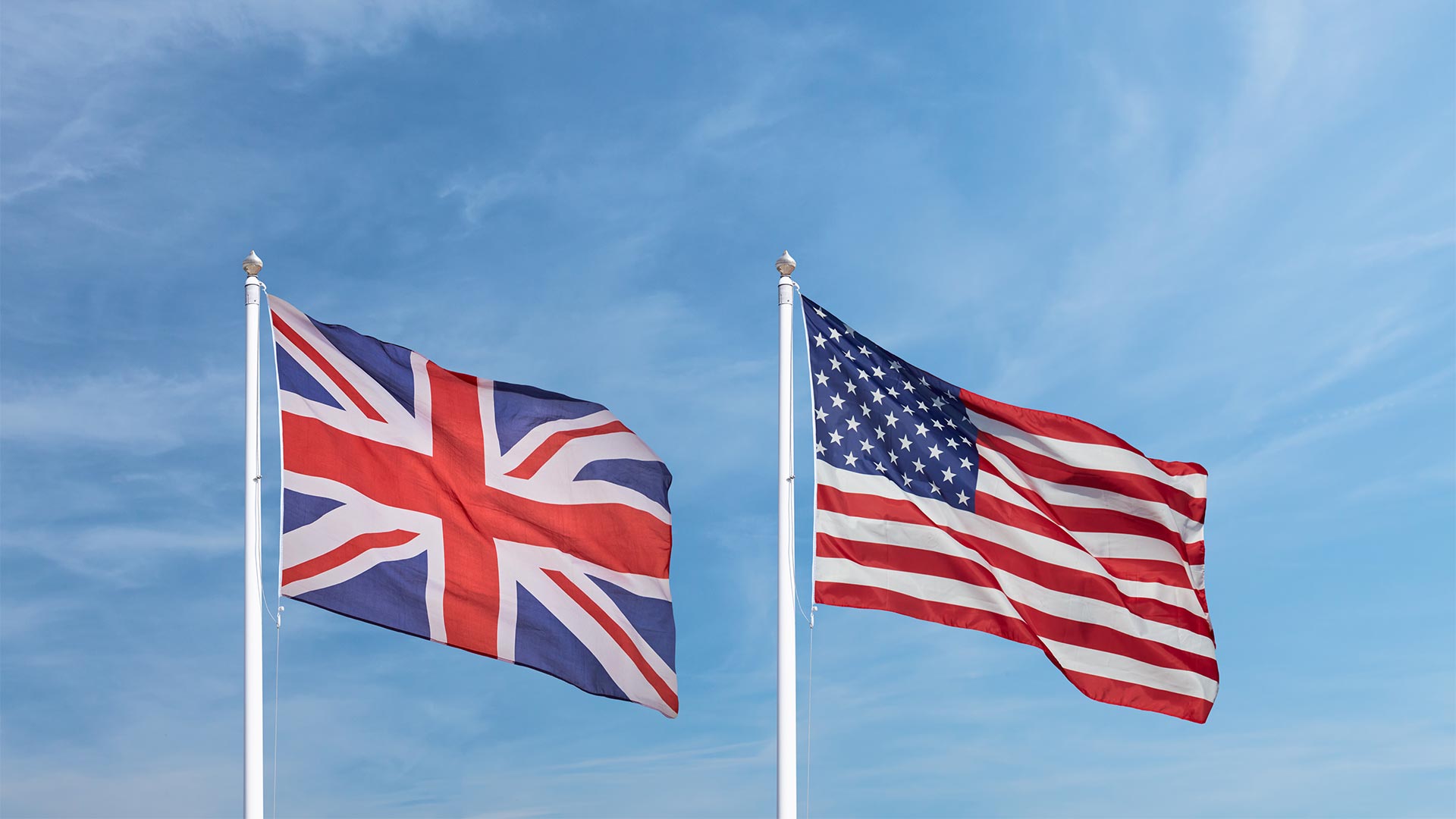 The UK and USA flags on poles