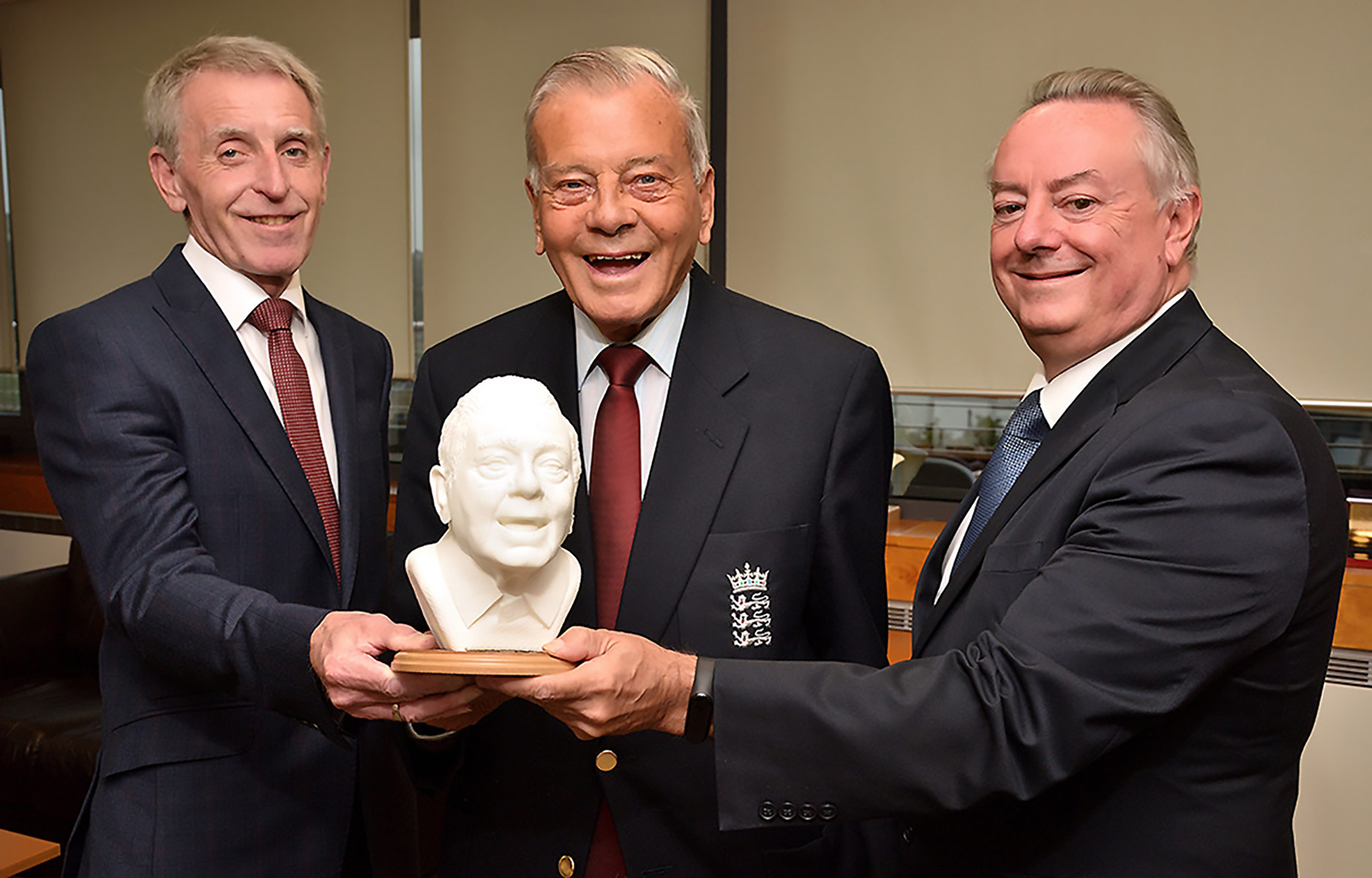 Dickie Bird pictured holding his 3D printed miniature bust alongside Colin Blair and Bob Cryan