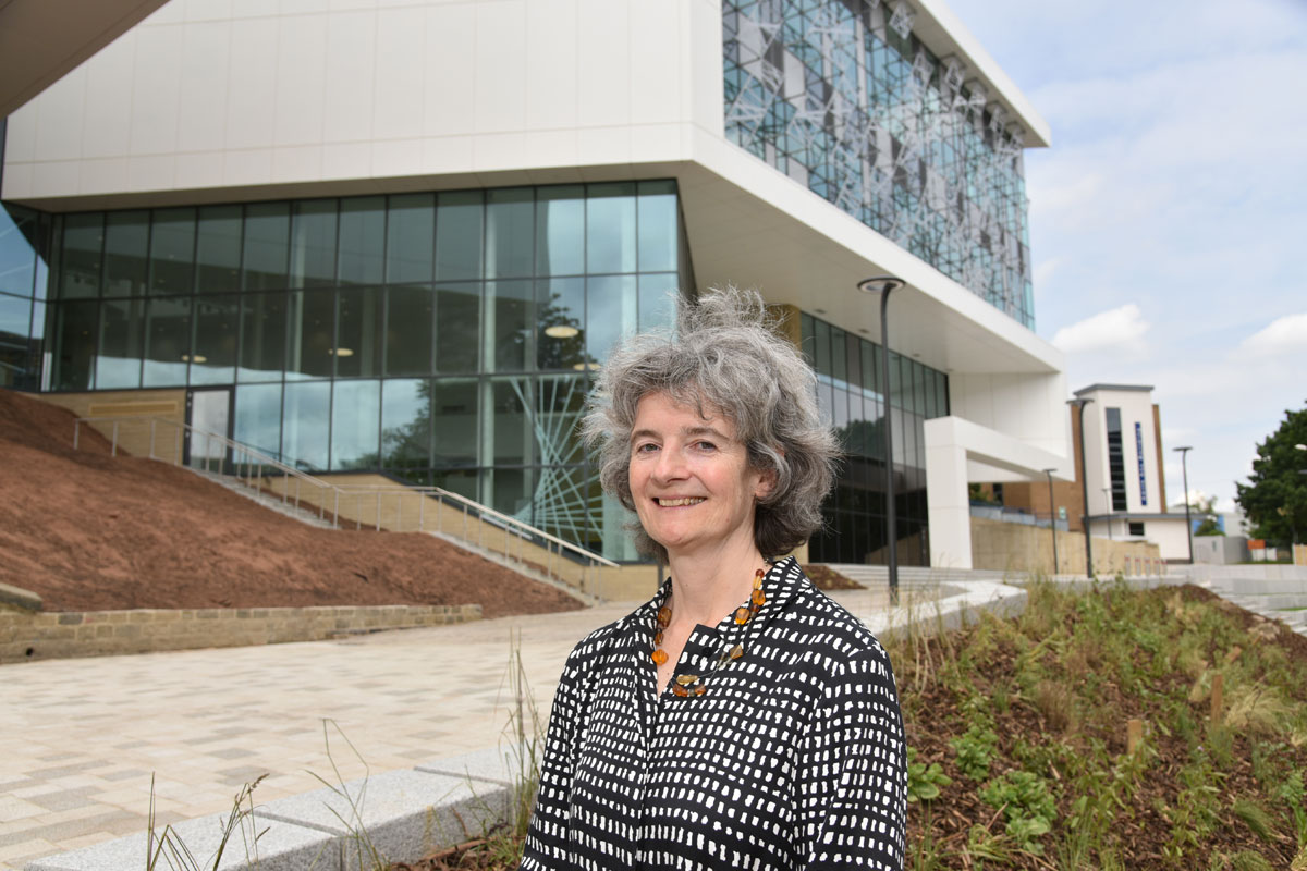 Dr Sophie Bowness standing in front of the new £30m Barbara Hepworth Building