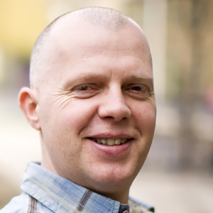 Professor Paul Thomas side profile photo of him smiling