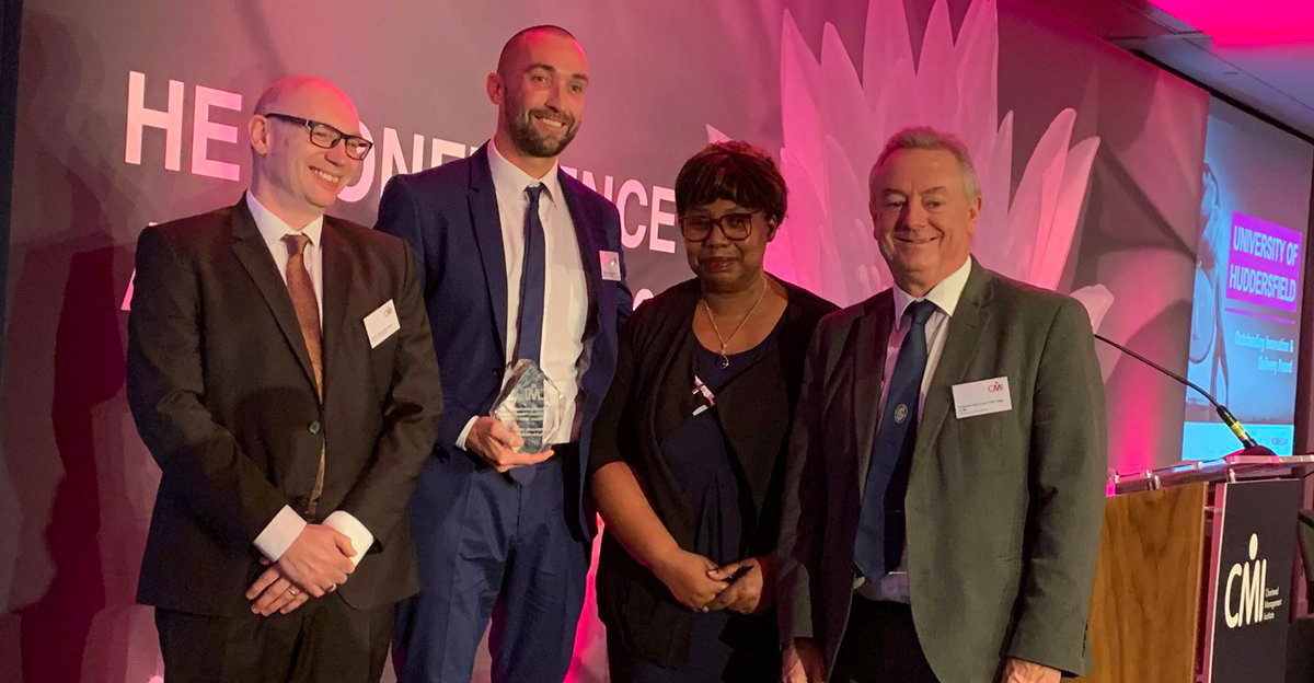 Pictured receiving the award for the University at the ceremony are Head of Staff Development Danny Benton (second left) and Professor Bob Cryan (right).