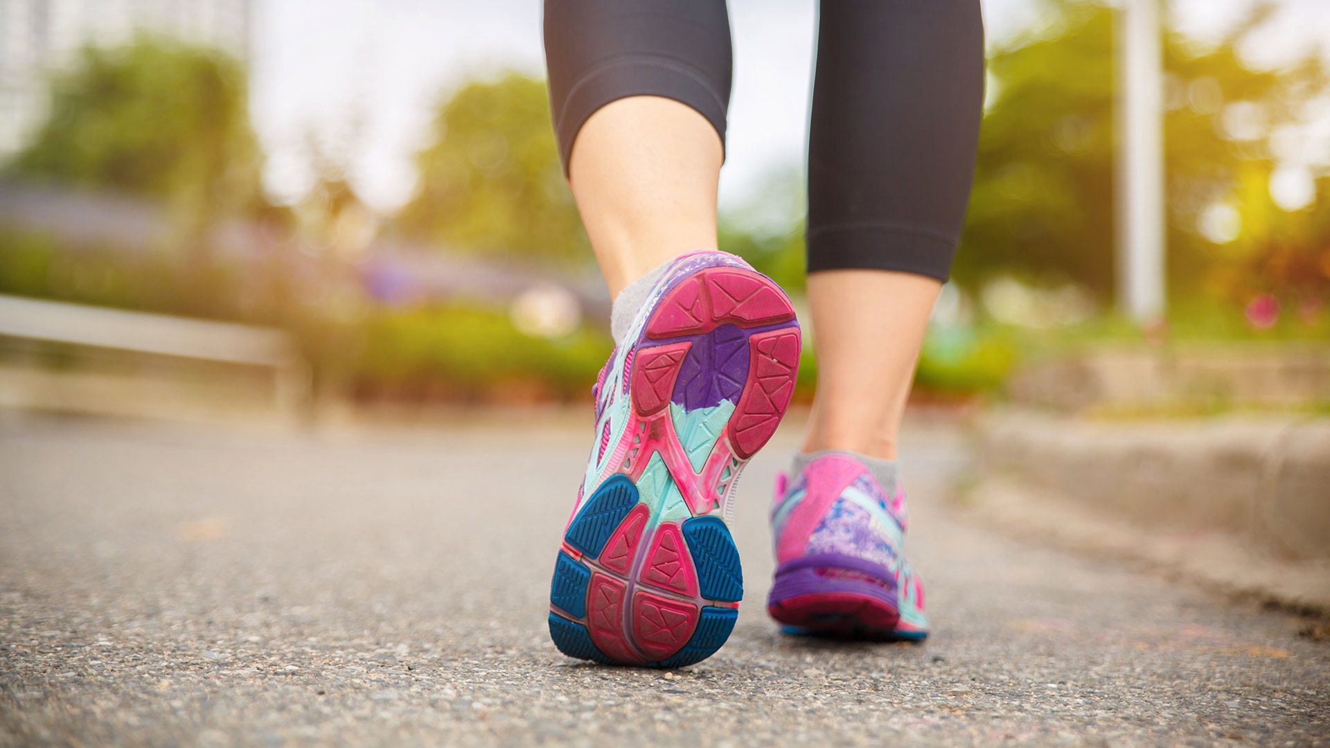 a close up of a person's trainers while running on a road