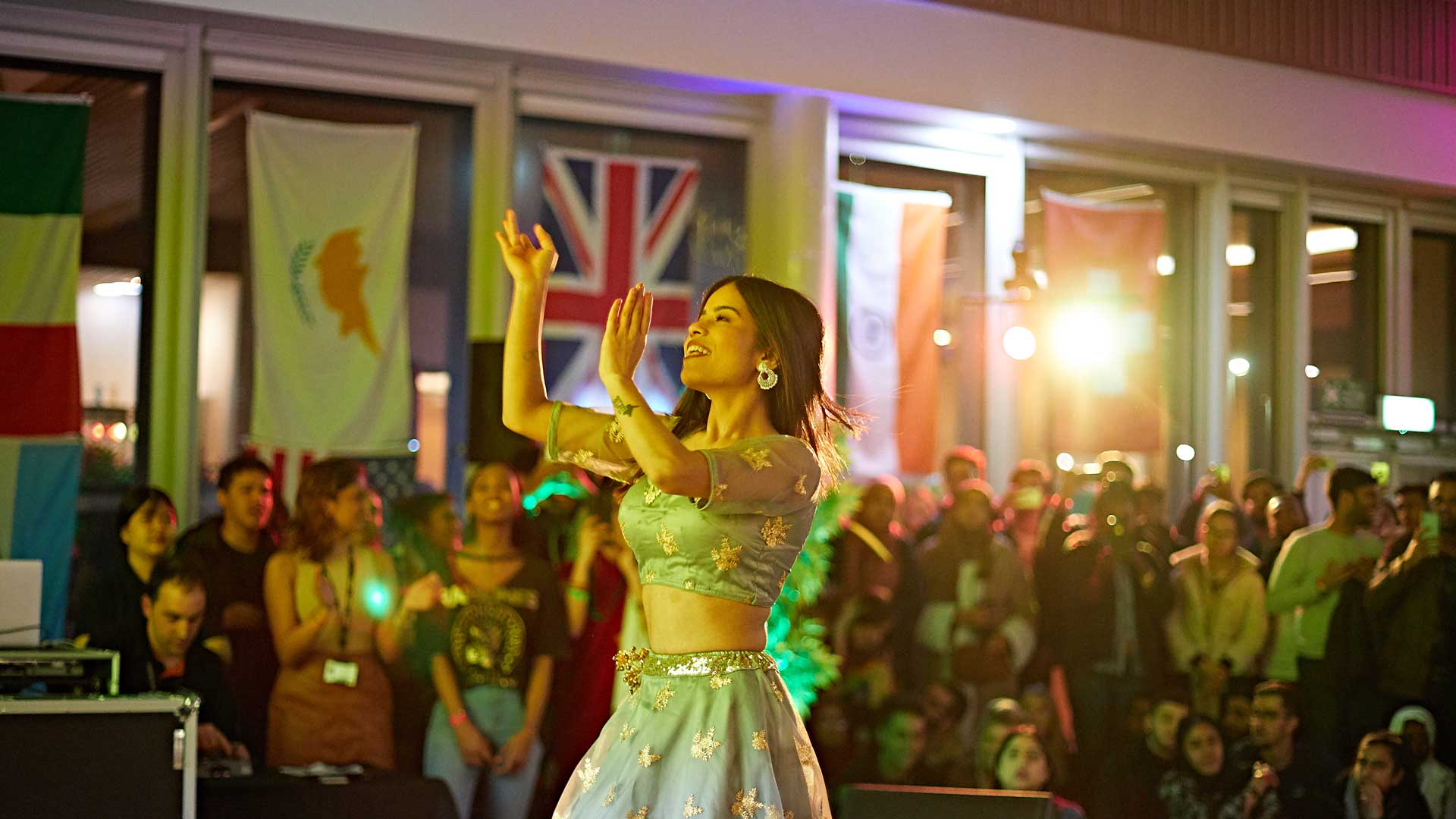 A student dancing in traditional dress at the Global Food and Culture Festival