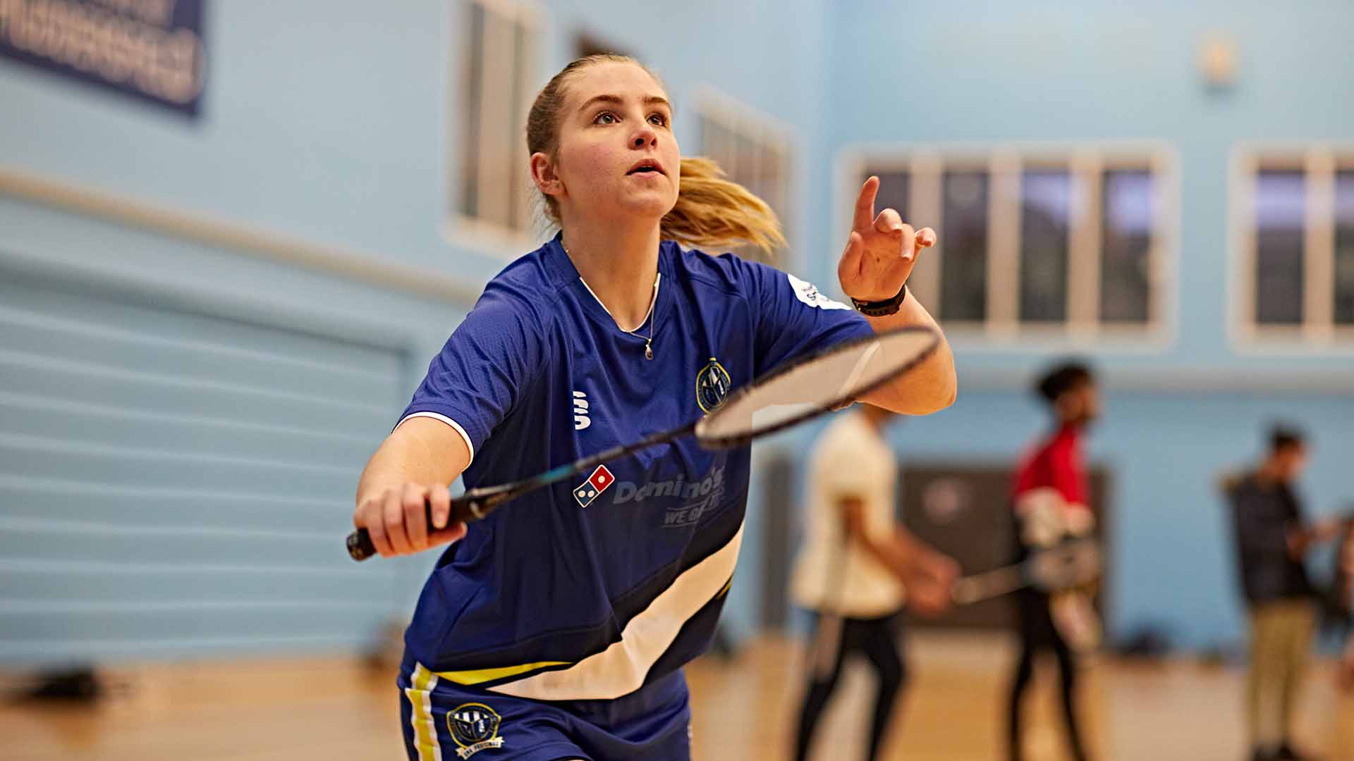 A female student playing badminton