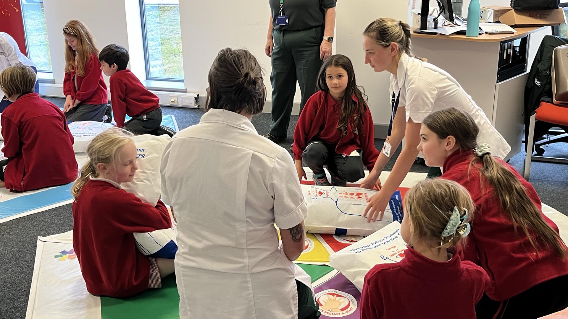 Kids are shown how to do CPR