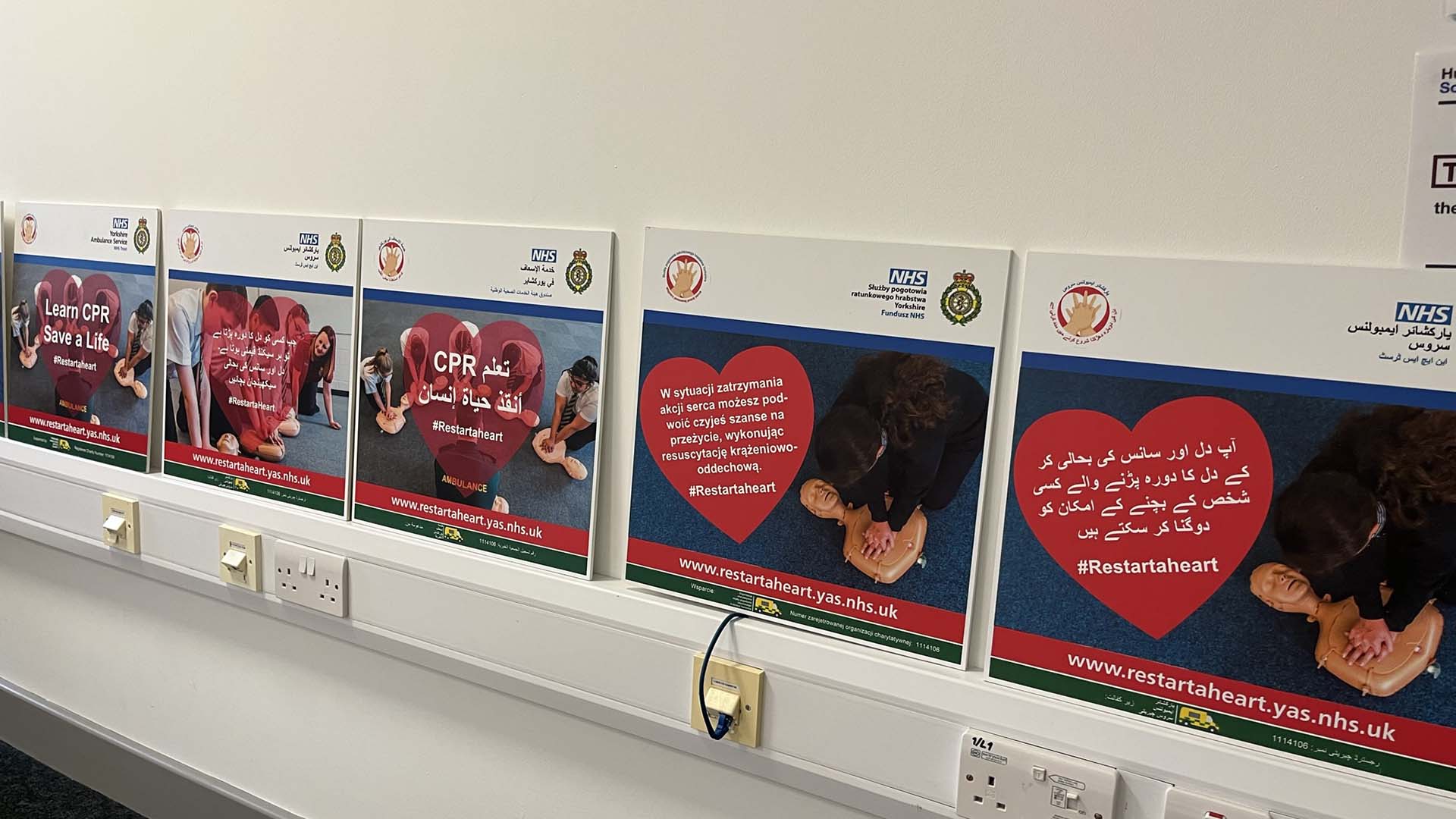 Signs in different languages showing how to do CPR