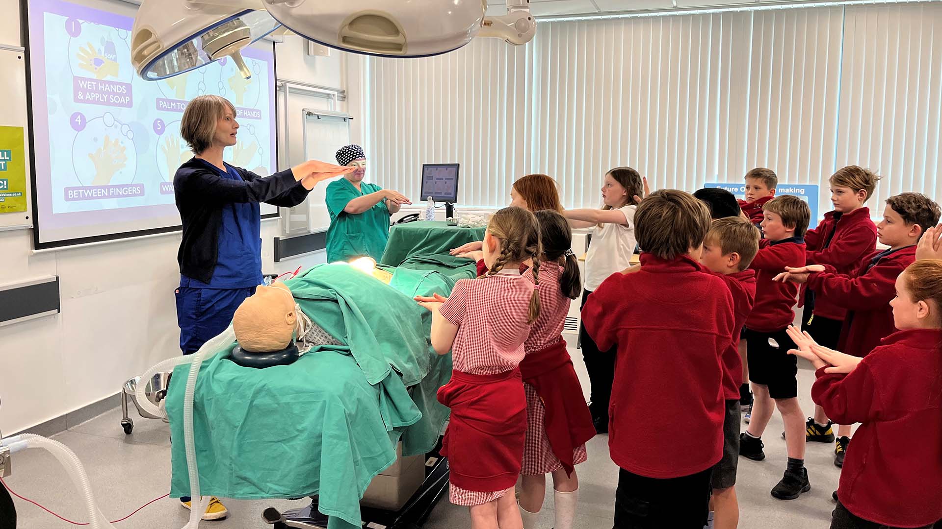 A medical teacher shows kids how to wash their hands properly