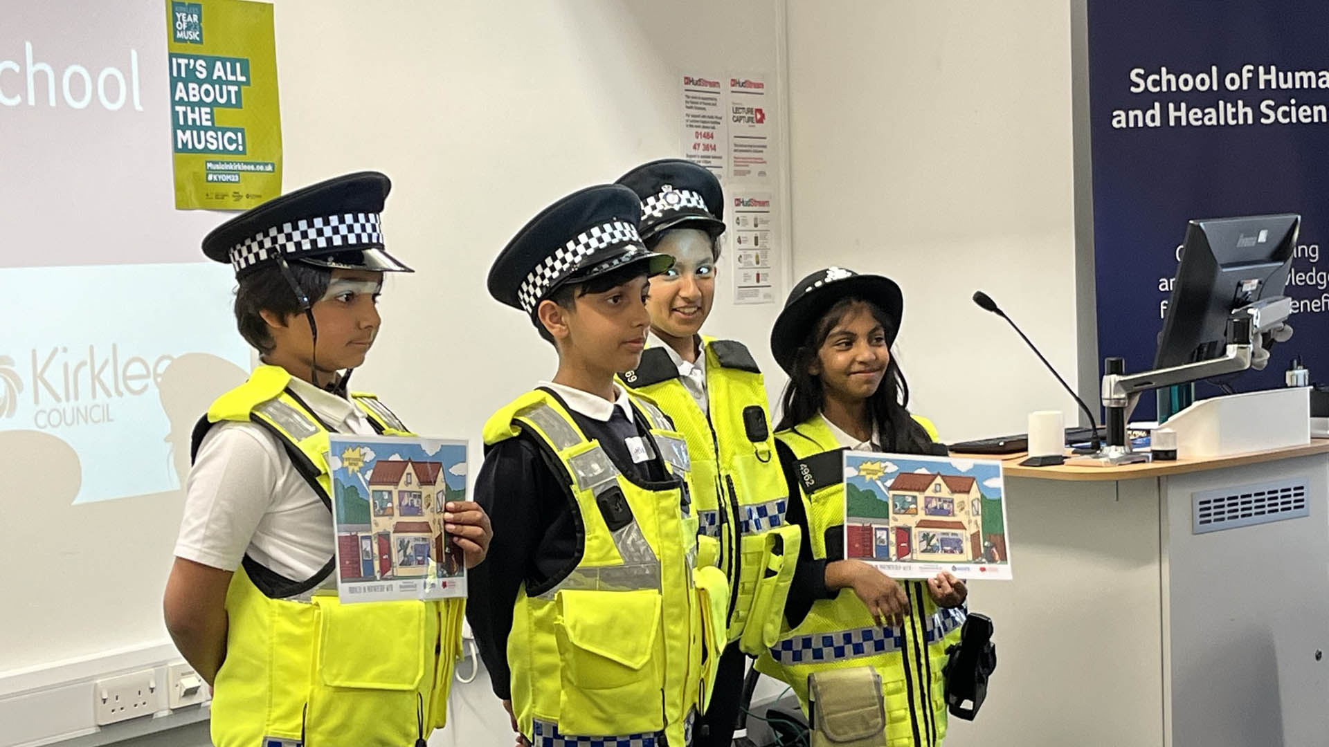 Children pose wearing police uniforms