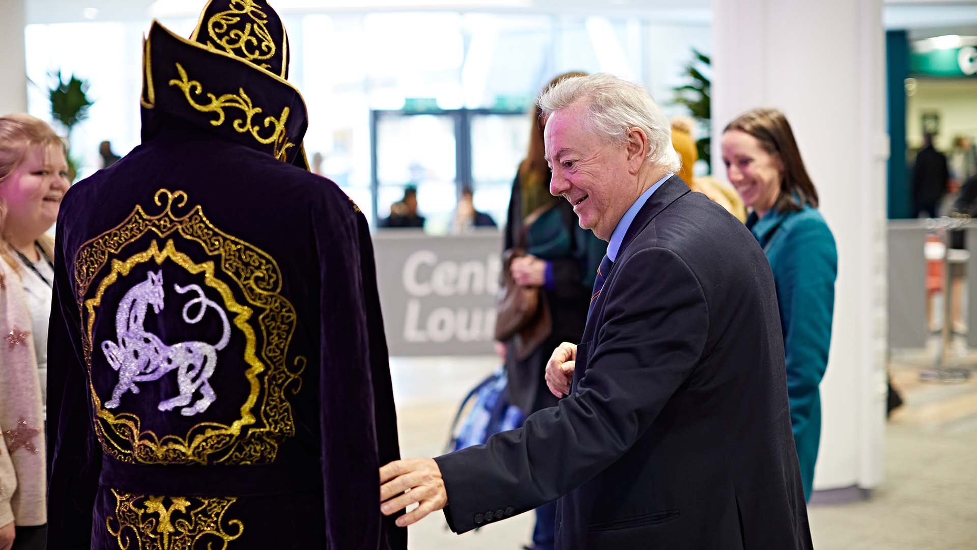 Vice chancellor Bob Cryan with a student in an elaborate costume