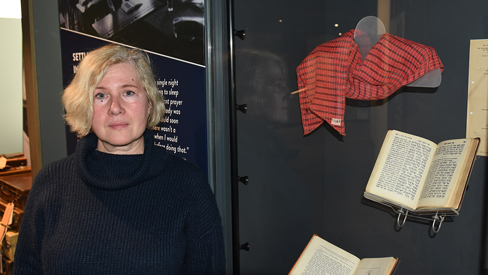 Tatiana Perga stands in the Holocaust Centre North by a display cabinet