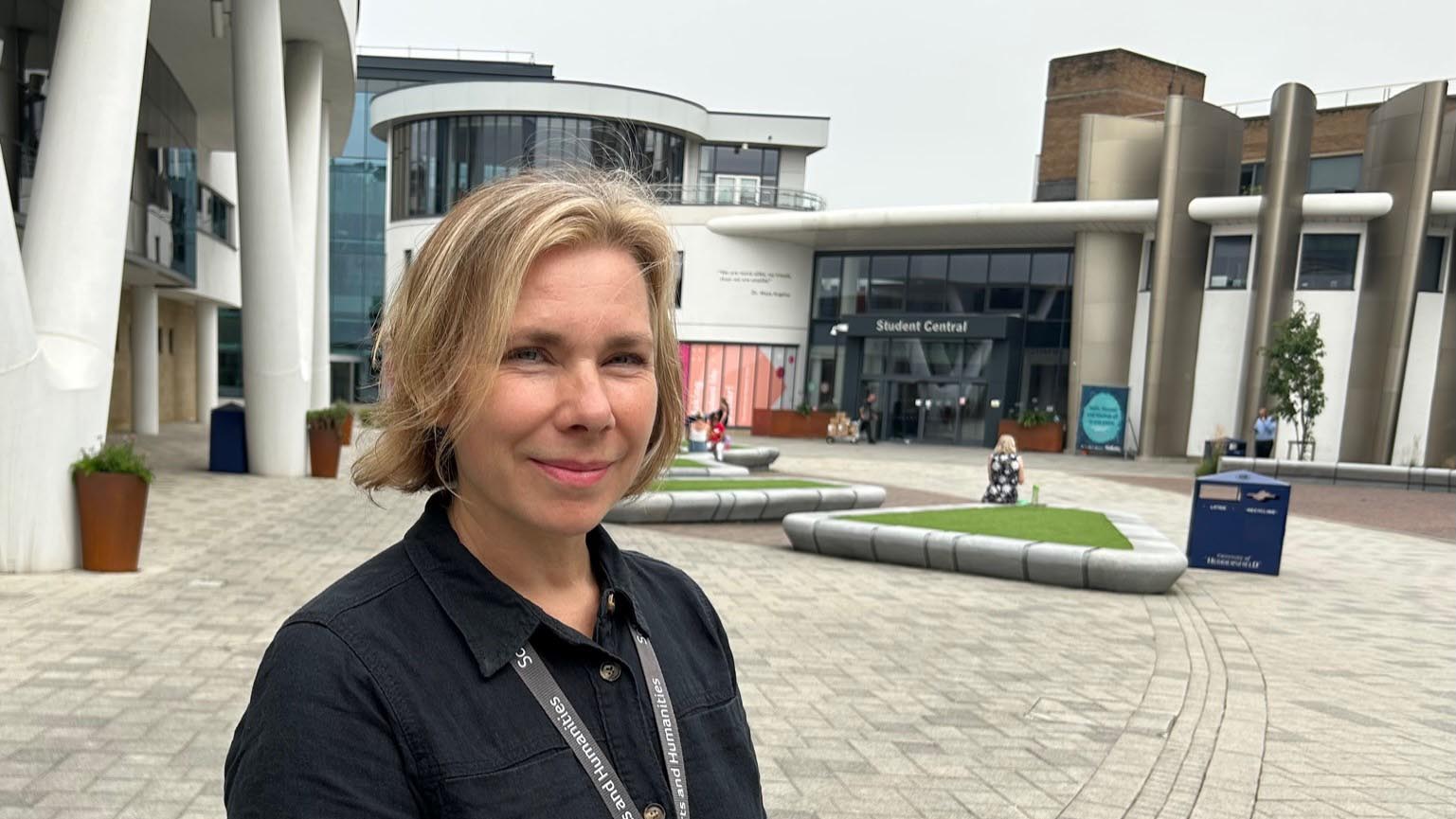 Jenny Gibson stands in front of Student Central at the University of Huddersfield