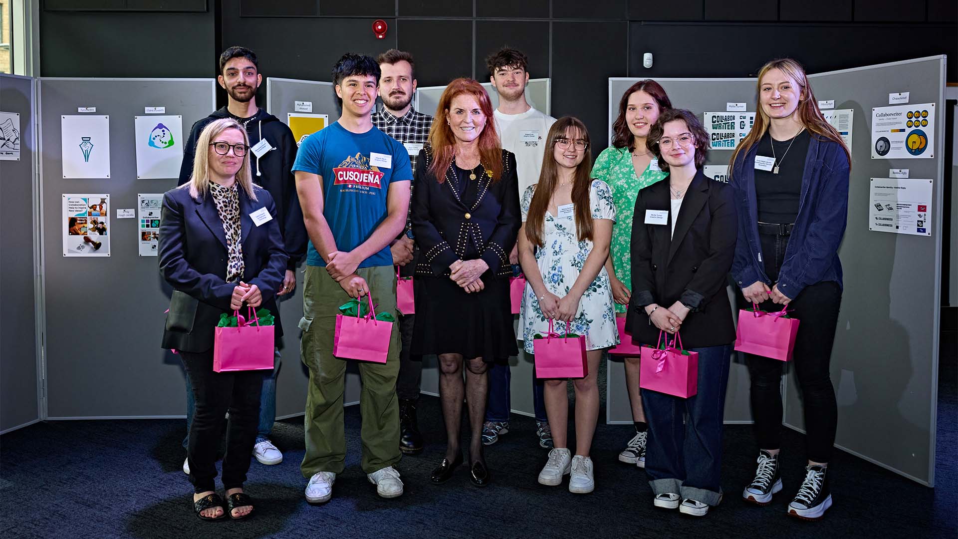 The Duchess of York with some design students standing in front of their designs