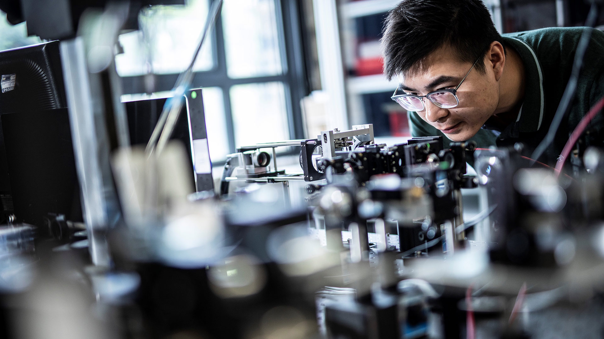 A scientist using equipment in a hi-tech lab