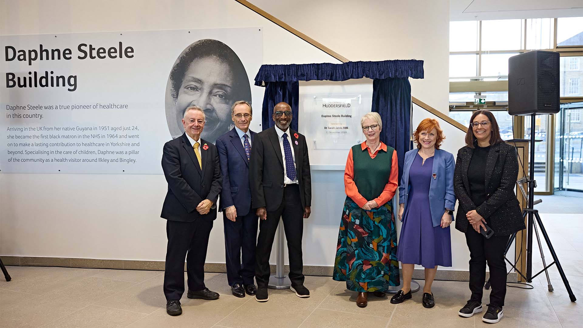 Robert Steele and other VIPs ate the opening of the Daphne Steele Building in front of a plaque