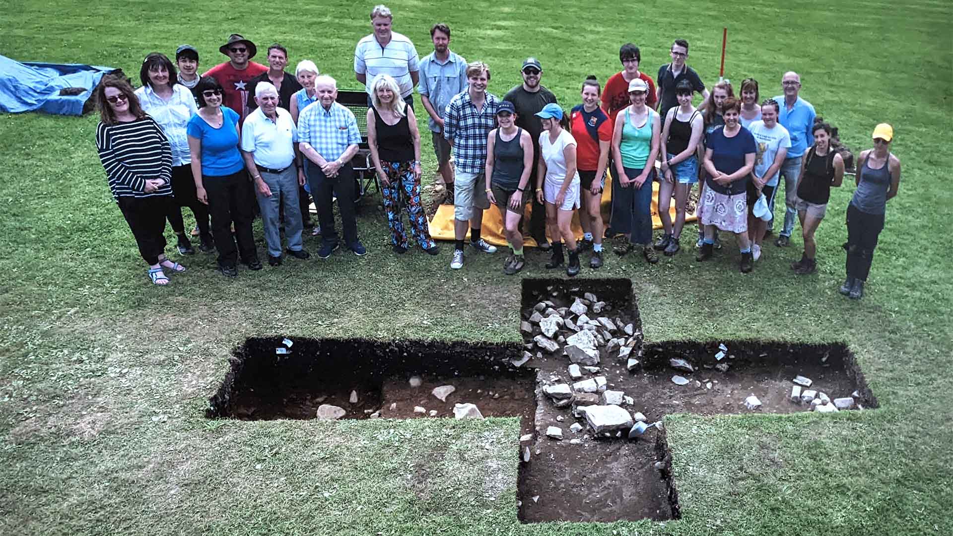 Archaeologists beside a dig in the Lake District