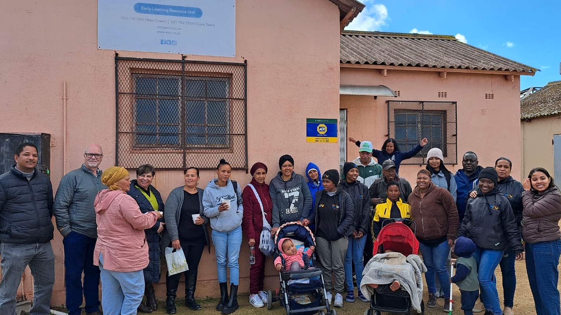 A group of families stood outside a community centre in South Africa