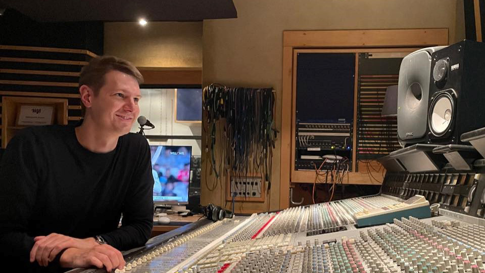 Adam Lunn at a mixing desk in a studio