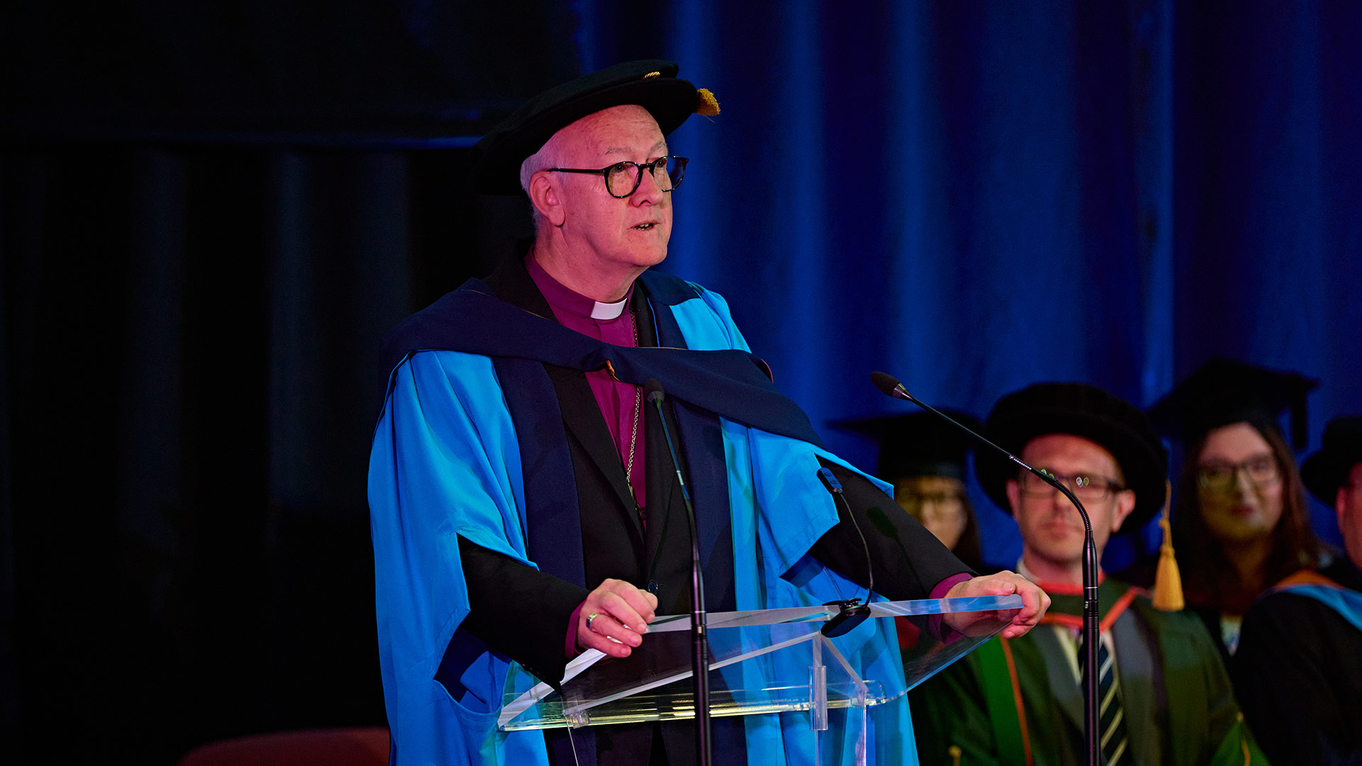 Rev Nick Baines on stage receiving an honorary doctorate