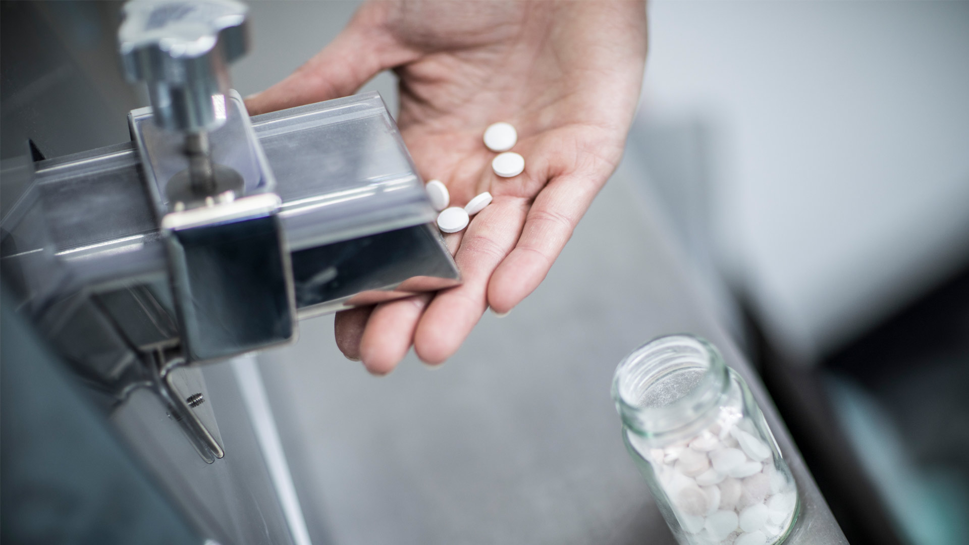 Drugs being dispensed and measured out in medical container
