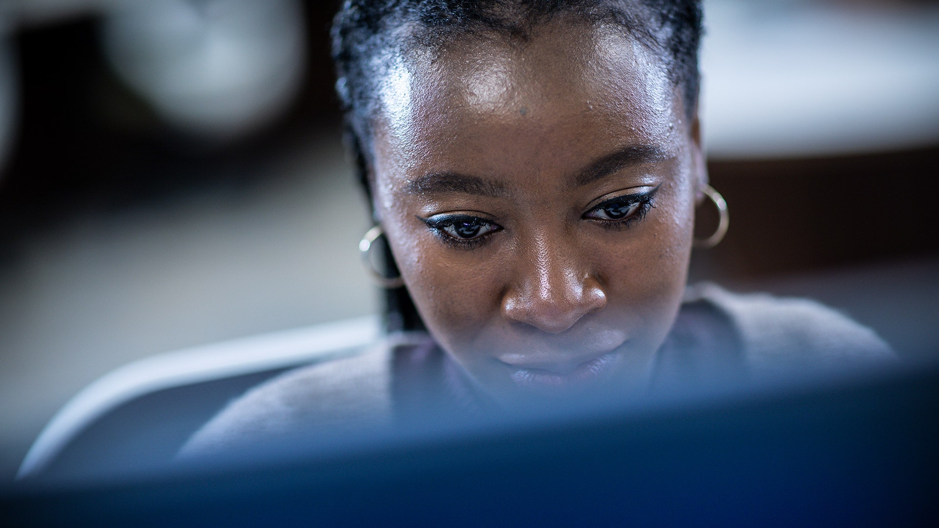 A closeup shot of a postgraduate student looking down at a computer screen.