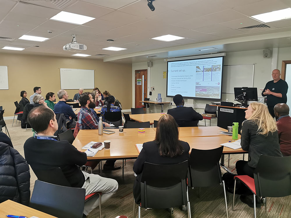 Staff and postgraduate research students watching a presentation at the Annual Research Conference