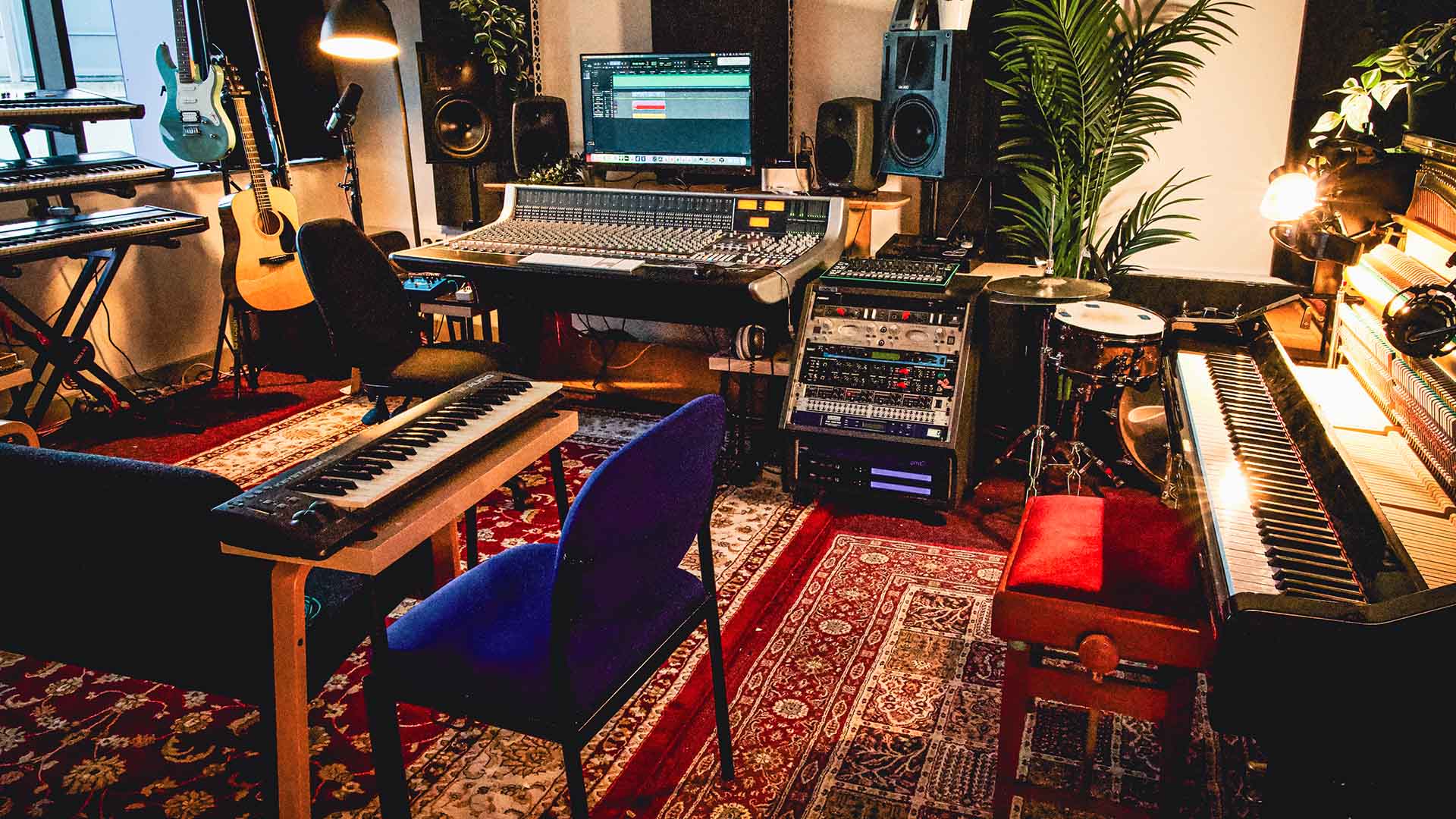 Songwriting studio with pianos and guitars