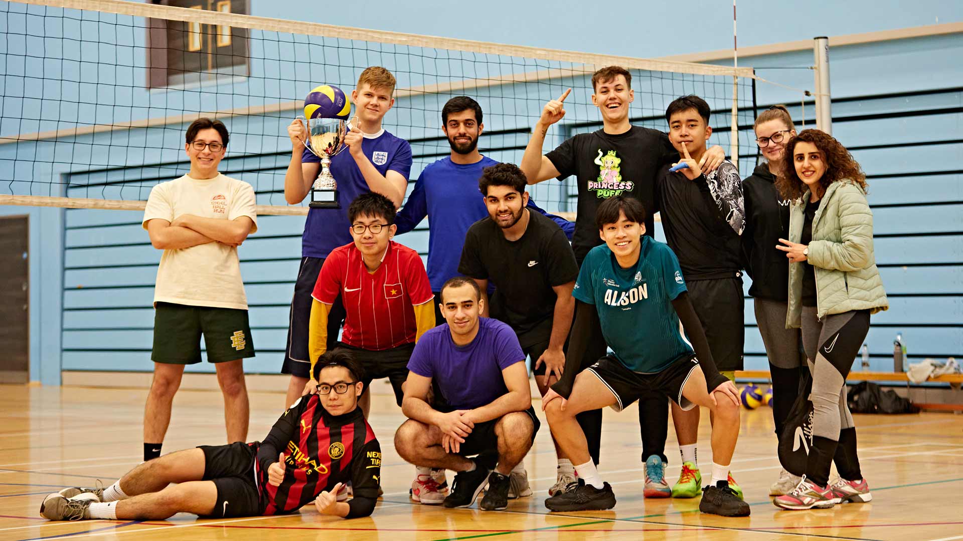 a group of students stood next to a badminton net