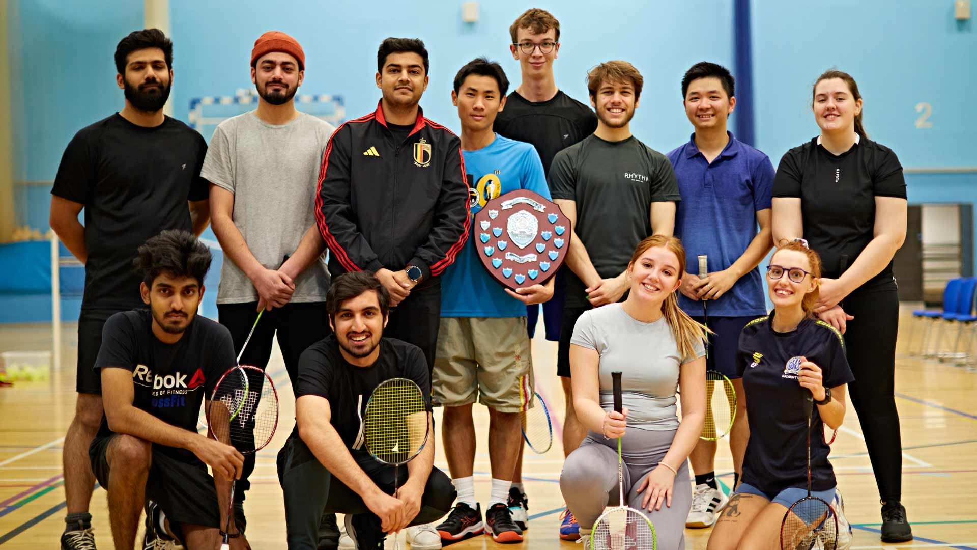 a group of students holding a trophy