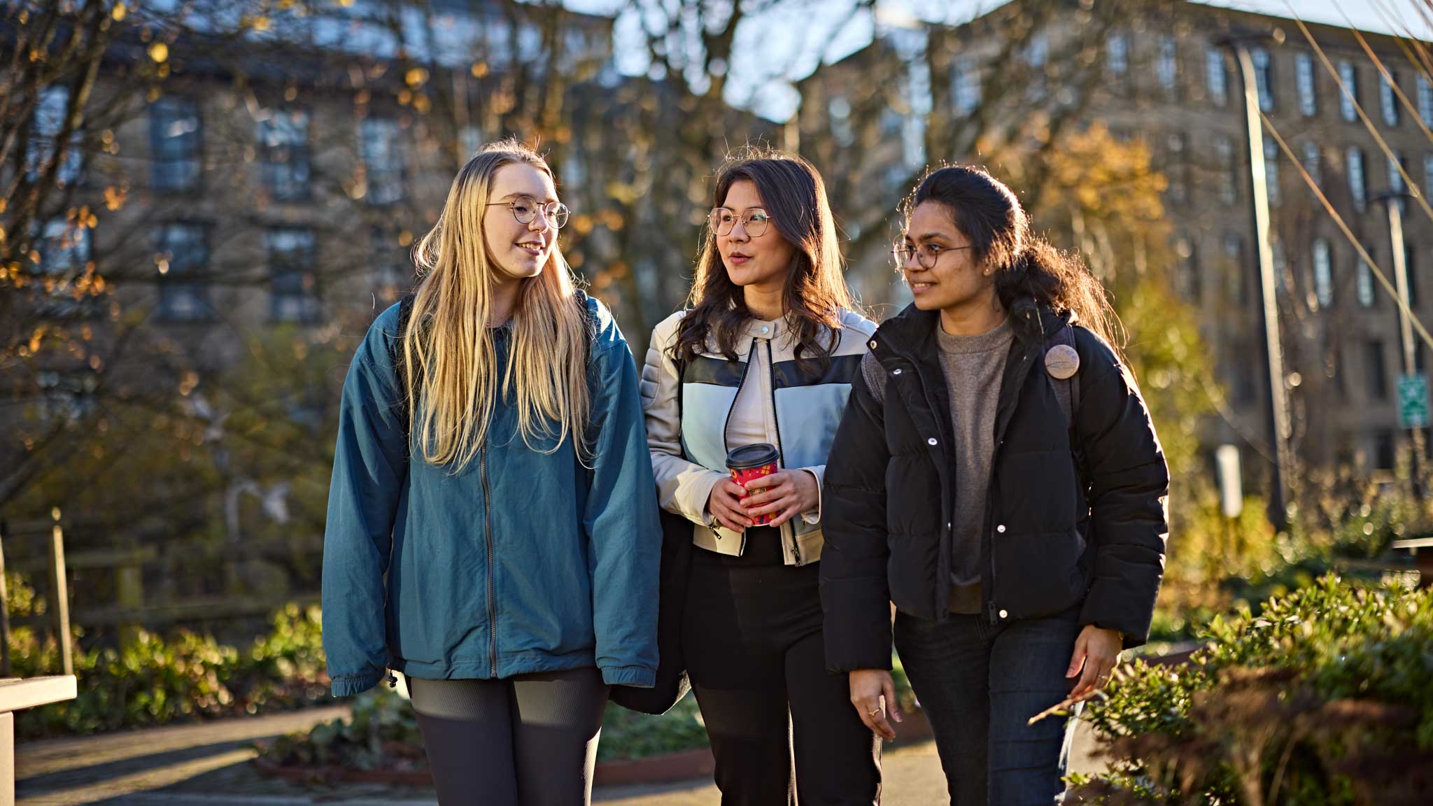 3 students walking around our campus