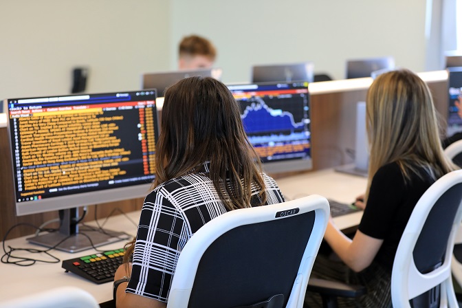 Students using pcs on campus on finance course