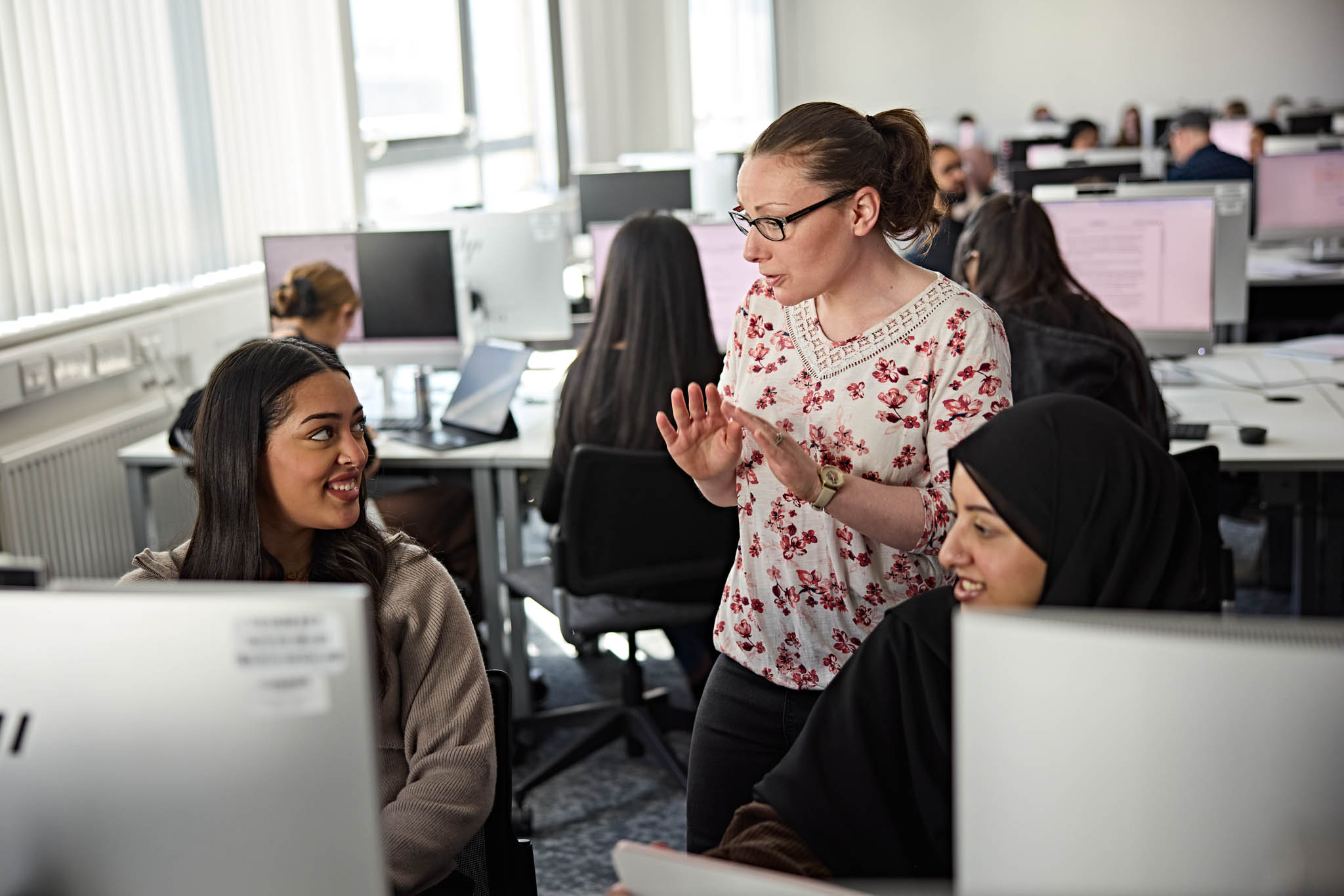 Students in a computer lab with their teacher
