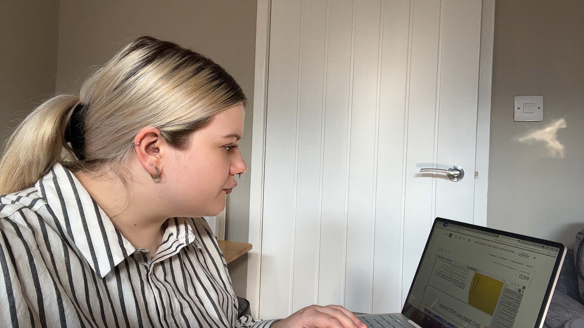 Emma sat working on her laptop.