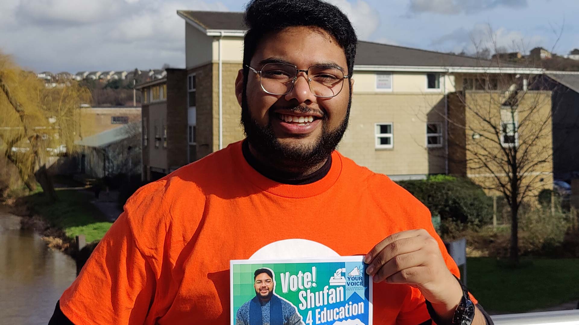 Shufan holding a poster to promote his campaign to become Education Officer for the Students' Union.