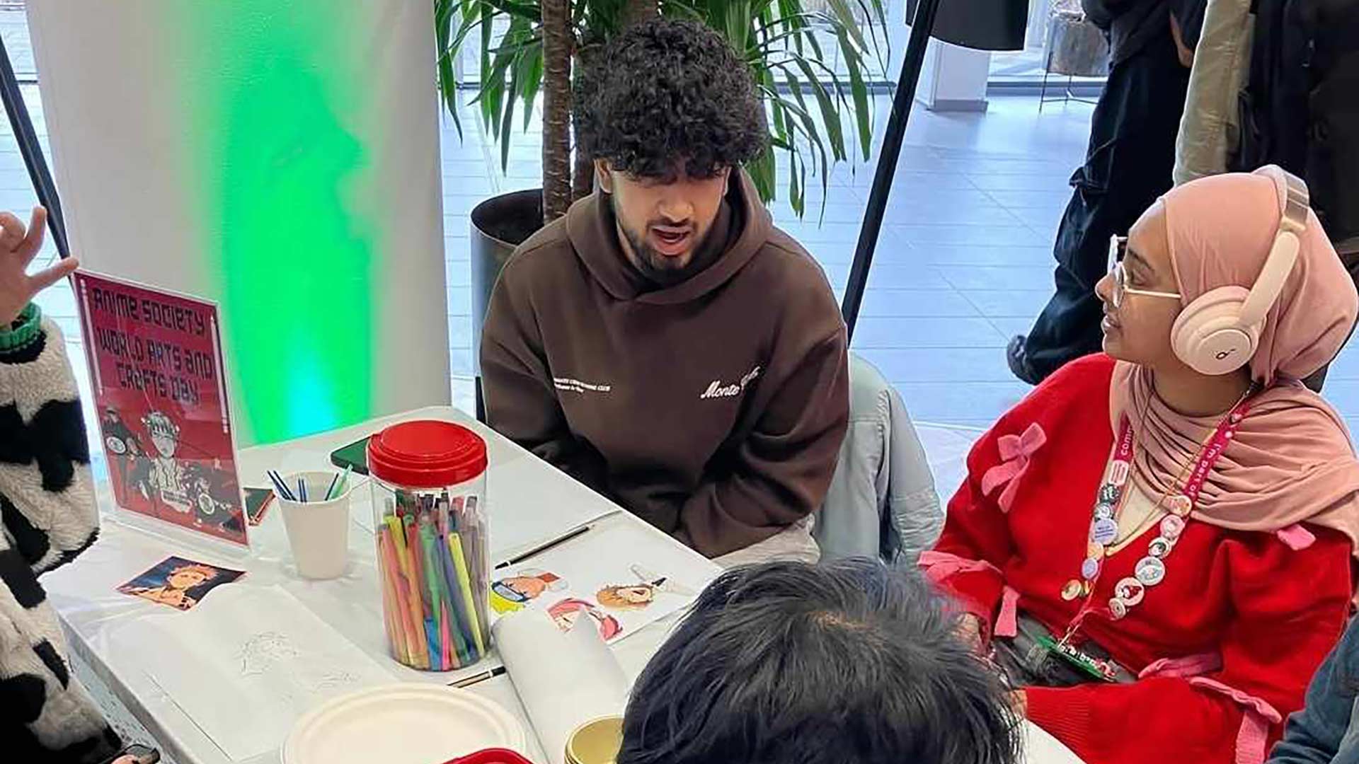 Syed sat at a stall for the Anime Society at an Arts and Crafts event on campus.